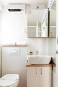 a bathroom with a sink and a toilet at Floating House Marina in Portorož +2 photos