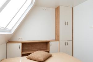 a room with white cabinets and a skylight at Floating House Marina in Portorož