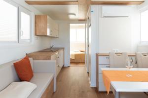 a kitchen and living room with a table and a table sidx sidx sidx at Floating House Marina in Portorož