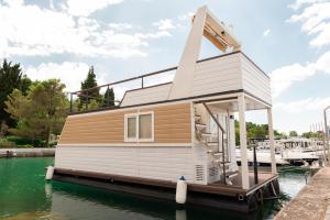 a tiny house on a dock in the water at Floating House Marina in Portorož