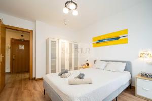 a bedroom with a large white bed in a room at Los Naranjos By Silastur in Ribadesella