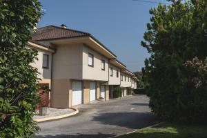 a row of apartment buildings on a street at Motel Venecia in Taboadela