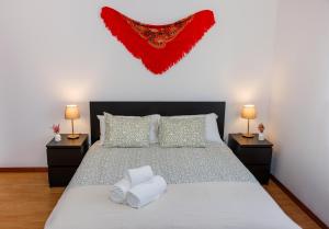 a bedroom with a bed with a red heart on the wall at Casa Belavista no Geres by In'Canto Property Management in Ponte da Barca