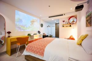 a bedroom with a large bed and a desk at take me 3seasons - hidden boutique home right at Han Market in Danang