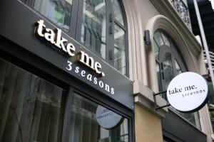 a sign on the side of a building at take me 3seasons - hidden boutique home right at Han Market in Danang