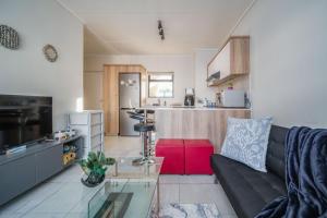 a living room with a couch and a kitchen at 366 Ballito Hills in Ballito