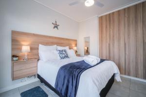 a bedroom with a large bed and a nightstand with a bed sidx sidx sidx at 366 Ballito Hills in Ballito +17 photos