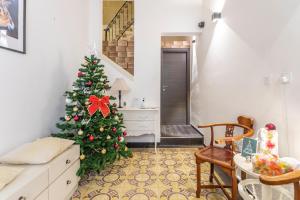 a living room with a christmas tree in the corner at Nemy Sliema Guesthouse in Sliema