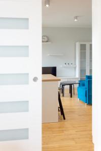 eine Küche und ein Wohnzimmer mit einer blauen Couch in der Unterkunft Szyndzielnia Park no 26 # kortem tenisowym, rowerownią # Nestapartamenty in Bielsko-Biała