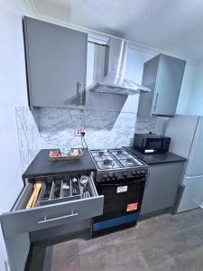 a kitchen with a stove and a counter top at House for 8 in Gillingham close to train station in Gillingham