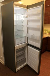 an empty refrigerator with its door open in a kitchen at COMBO noclegi pracownicze, dla firm 