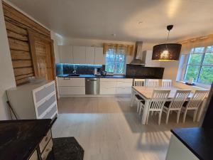a kitchen with a table and chairs in a room at Grete's House in Eurajoki