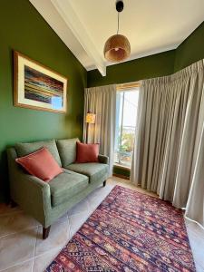 a living room with a couch and a window at Moonrise Cove in Pelican Lagoon
