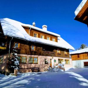 a house with snow on the roof of it at Karnerhof in Mariapfarr