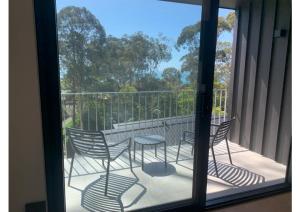 a balcony with chairs and a table on a balcony at Perch Lorne in Lorne
