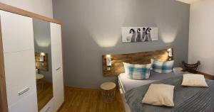 a bedroom with a bed with a wooden headboard at Ferienwohnung Eisenach Meyer in Eisenach