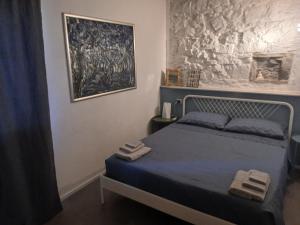 a bedroom with a bed and a painting on the wall at Casa in Montagna in Porretta Terme