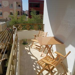 a patio with chairs and a table on a balcony at Hurghada Red Sea Apartments in Hurghada
