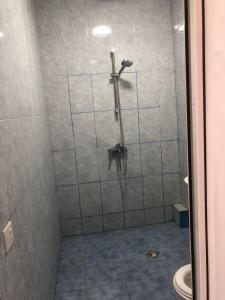 a bathroom with a shower with a toilet at İzmir can hotel in Baku