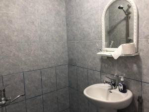 a bathroom with a sink and a mirror at İzmir can hotel in Baku