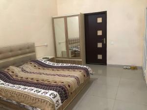 a bedroom with a bed and a large mirror at İzmir can hotel in Baku