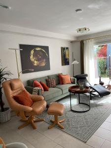 a living room with a couch and a table at Ferienwohnung Buntspecht in Bad Wildbad