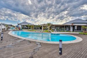 a pool at a resort with a cloudy sky at 366 Ballito Hills in Ballito