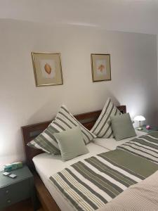 a bedroom with two beds with striped pillows at Ferienwohnung Buntspecht in Bad Wildbad +33 photos