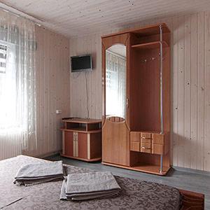 a bedroom with a bed and a mirror and a dresser at Вікторія Ретрит центр in Zhukovtsy