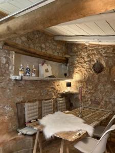 a room with two chairs and a table with a white rug at Terre de Caliso in Carnoules