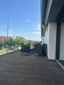a patio with chairs and a table on a building at Bioweingut Glaser in Hainfeld