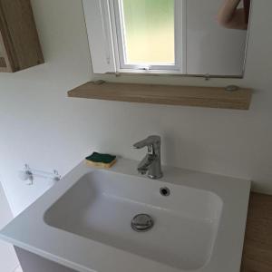 a white sink in a bathroom with a window at Les Ch'tis Normands 2! in Litteau