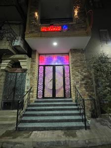 a staircase with a stained glass window and a sign at Al FAHAD private apartments for rent in Luxor +5 photos