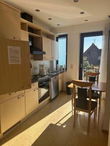 a kitchen with a table and a table and a dining room at Bioweingut Glaser in Hainfeld