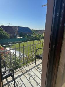 a balcony with two benches and a view of a field at Bioweingut Glaser in Hainfeld +9 photos