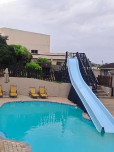 a slide in front of a swimming pool at Banana Beach Club C5 in Port Shepstone