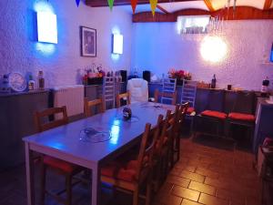 a dining room with a table and some chairs at Chata Alexandra in Karlovy Vary