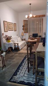 a bedroom with a bed and a table and a desk at Villa Asimidou in Agia Paraskevi