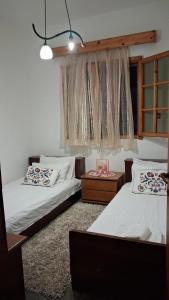 a bedroom with two beds and a window at Villa Asimidou in Agia Paraskevi +69 photos