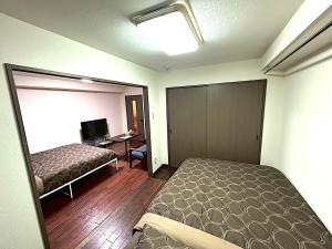 Postel nebo postele na pokoji v ubytování KIYAZA Louvre Sapporo