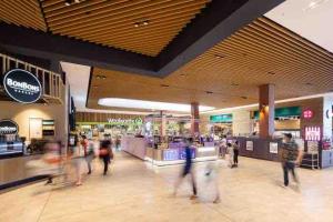 a group of people walking through a shopping mall at Full of Fun shopping 1BR stay at Clayton in Clayton North