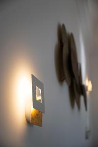 a light with a letter on a wall at Dimora de Feo in Amalfi
