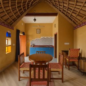 a dining room with a table and chairs at IRWINA-In rhythm with nature in Pushkar
