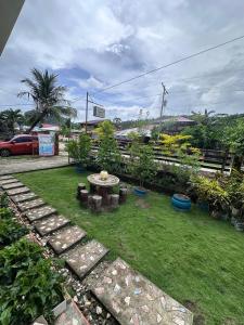 a garden with a table and rocks in the grass at Subangan Veranda1, Burgos Central location in Burgos +26 photos