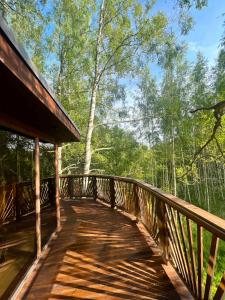 a wooden bridge in the middle of a forest at Lootvina Houses - Linnast välja, puu otsa! in Lootvina