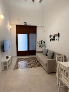 a living room with a couch and a tv at K&A Apartments in Valencia