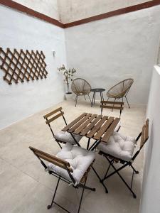 a group of chairs and a wooden table in a room at K&A Apartments in Valencia