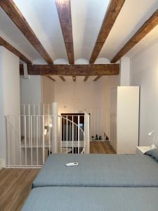a bedroom with a bed and wooden ceilings at K&A Apartments in Valencia