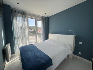 Ένα ή περισσότερα κρεβάτια σε δωμάτιο στο Apartamento con vistas al mar en la playa de Somo