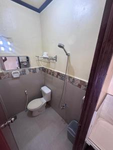 a bathroom with a toilet and a shower at Subangan Veranda1, Burgos Central location in Burgos